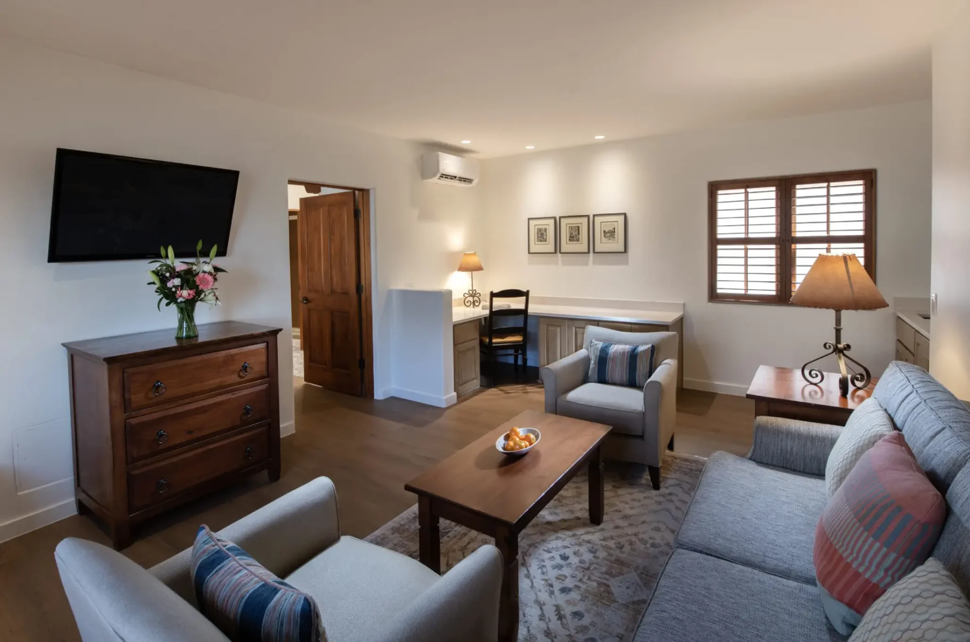 a living room filled with furniture and a flat screen tv