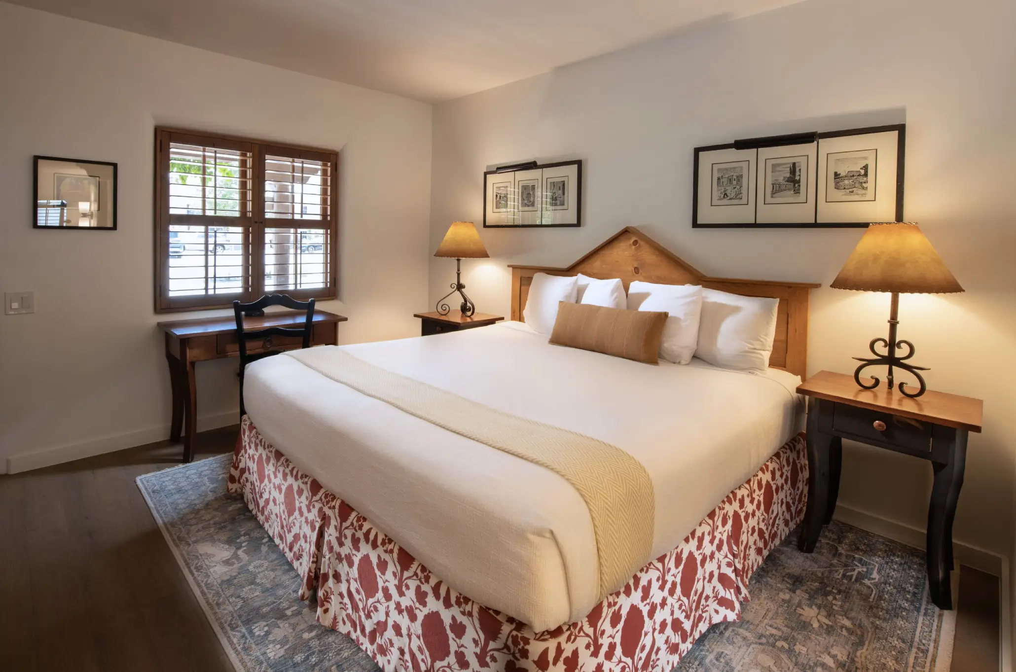 a bedroom with a bed and two lamps on either side of the bed