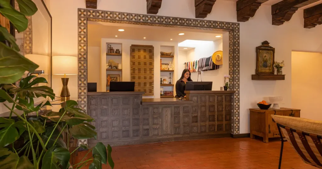 The Piñon Court check-in area features a rustic wooden reception desk and Spanish colonial decor in this Napa Valley hotel.