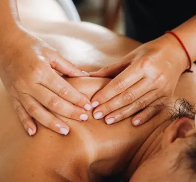 Close-up of a deep tissue massage on a client's oily back, characteristic of napa hotels with spa services.