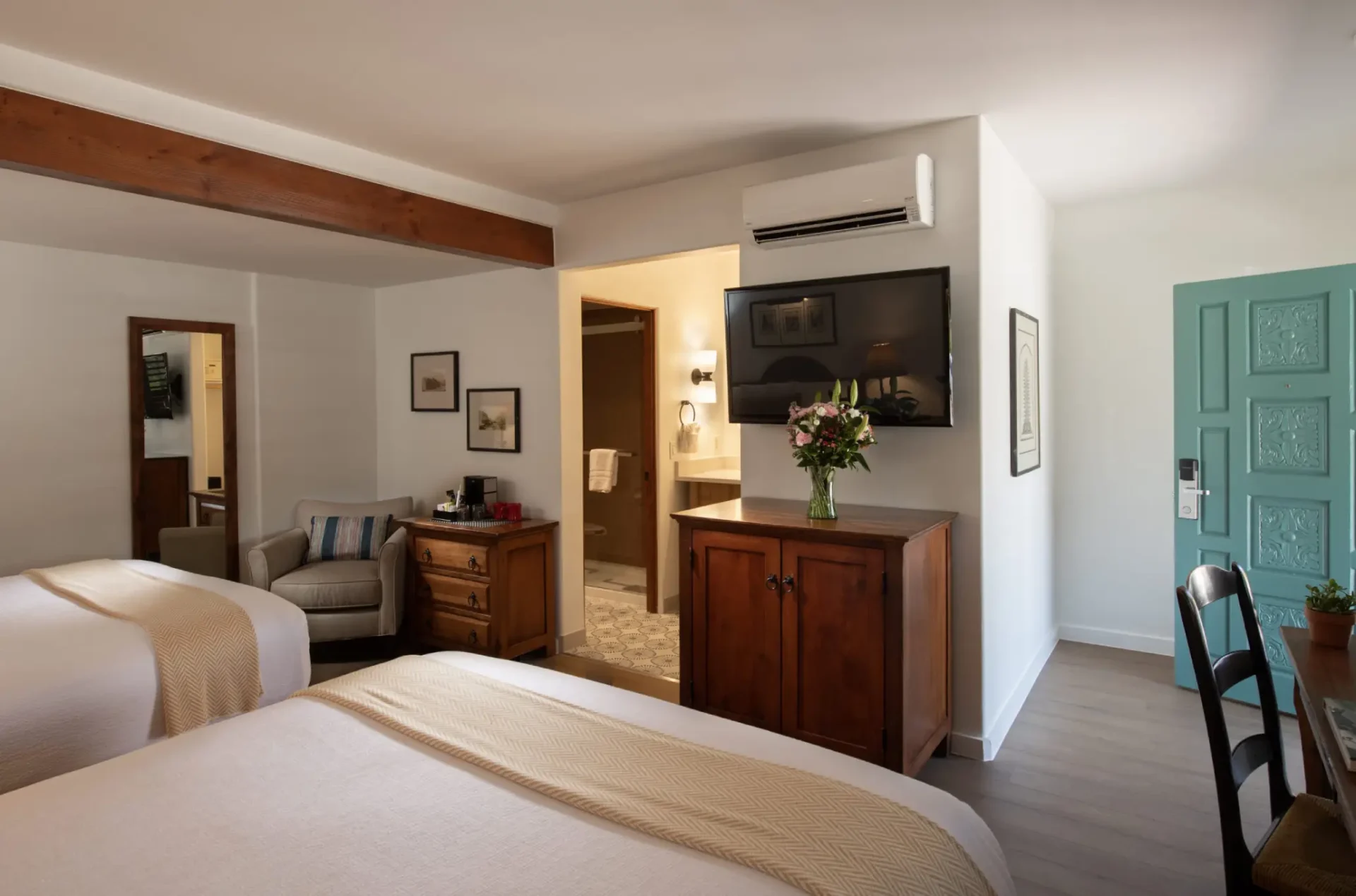 a hotel room with two beds and a desk